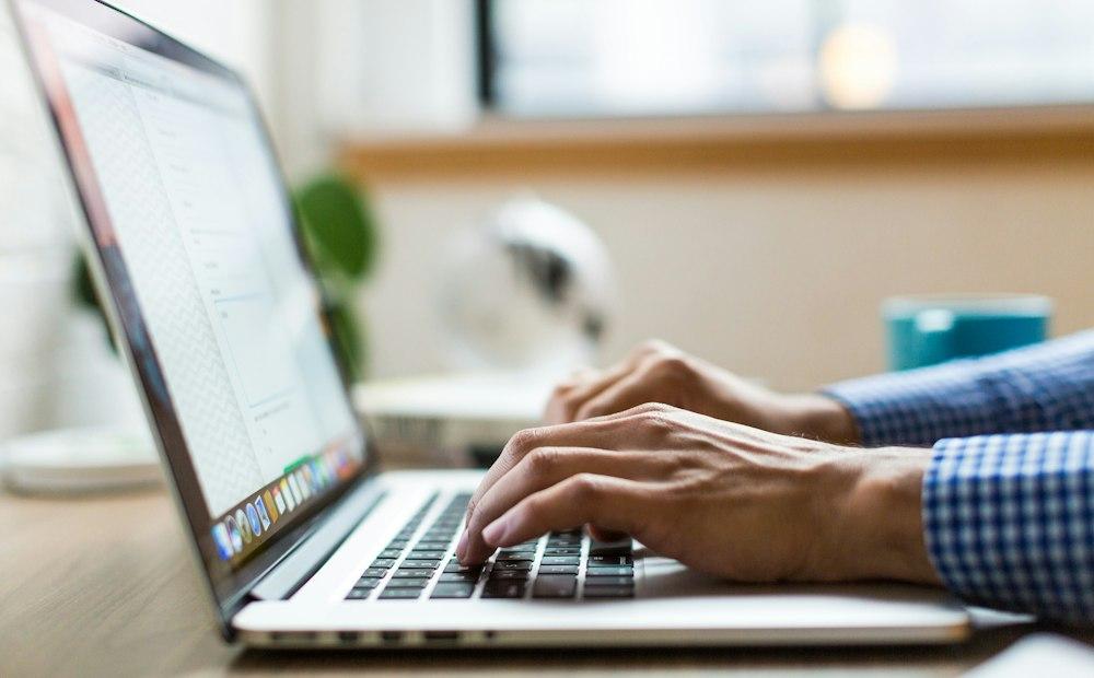 Typing a script on a laptop to generate speech